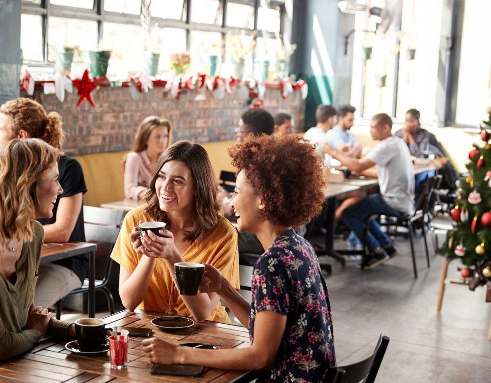 Guests enjoying coffee in a busy cafe